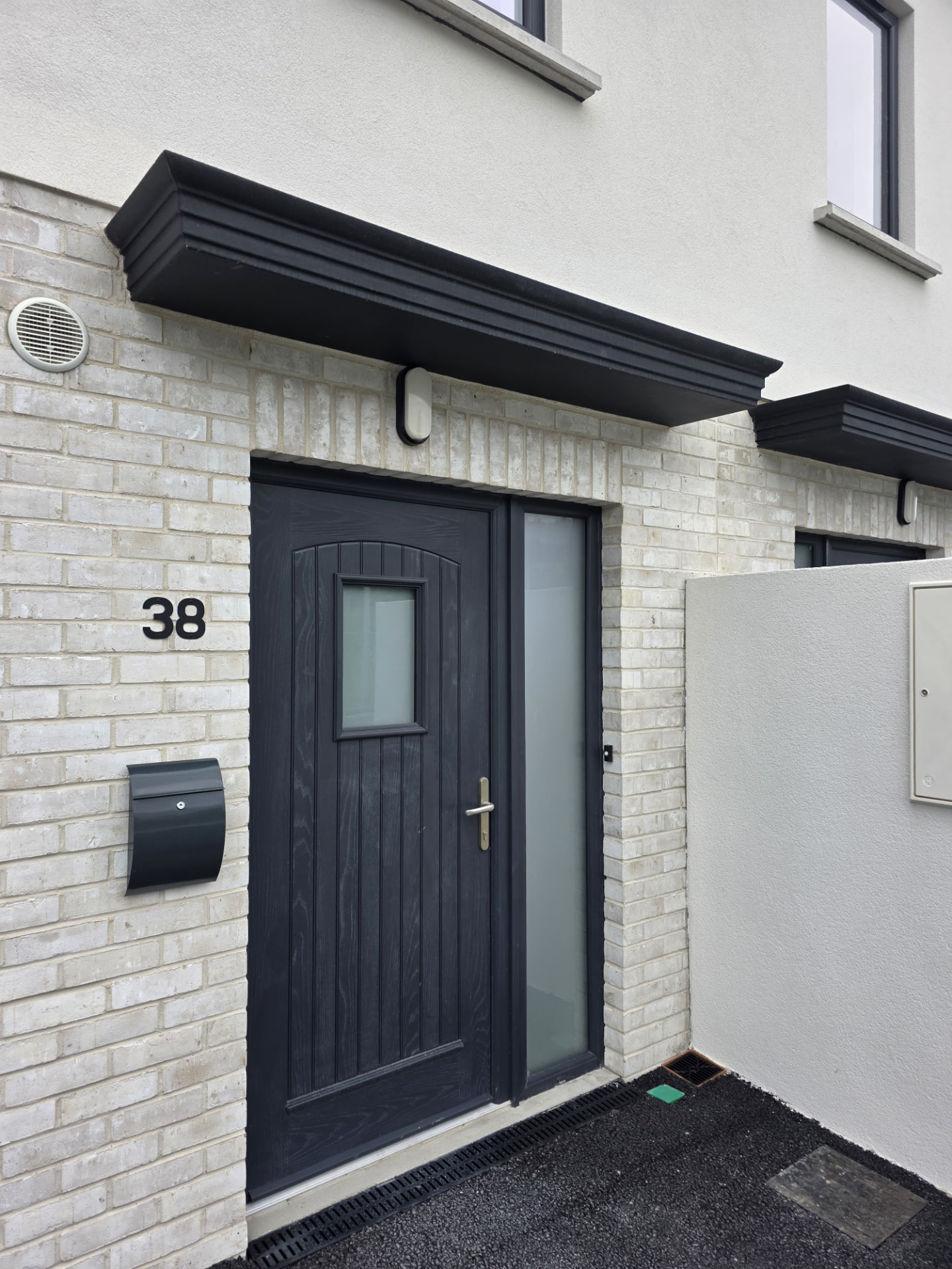 Black M9 entrance canopy installed over a front door