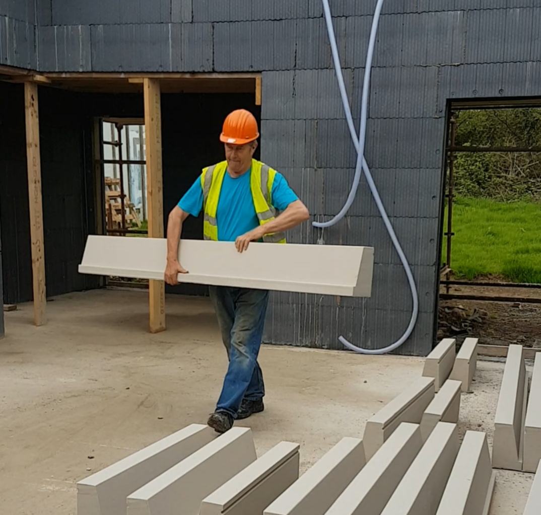 Installer carrying a lightweight CCRM window sill on site